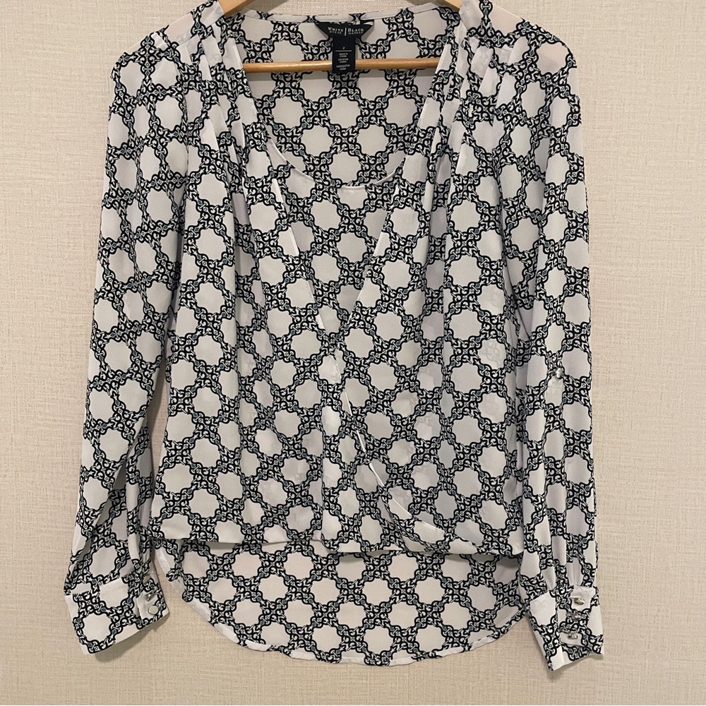 White House Black Market white mock wrap blouse with black and green pattern.